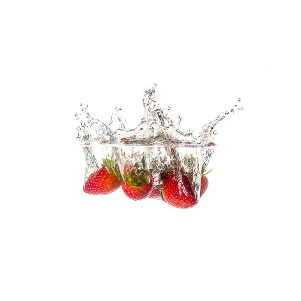 Strawberries splash on water, isolated on white background — Stock Photo, Image