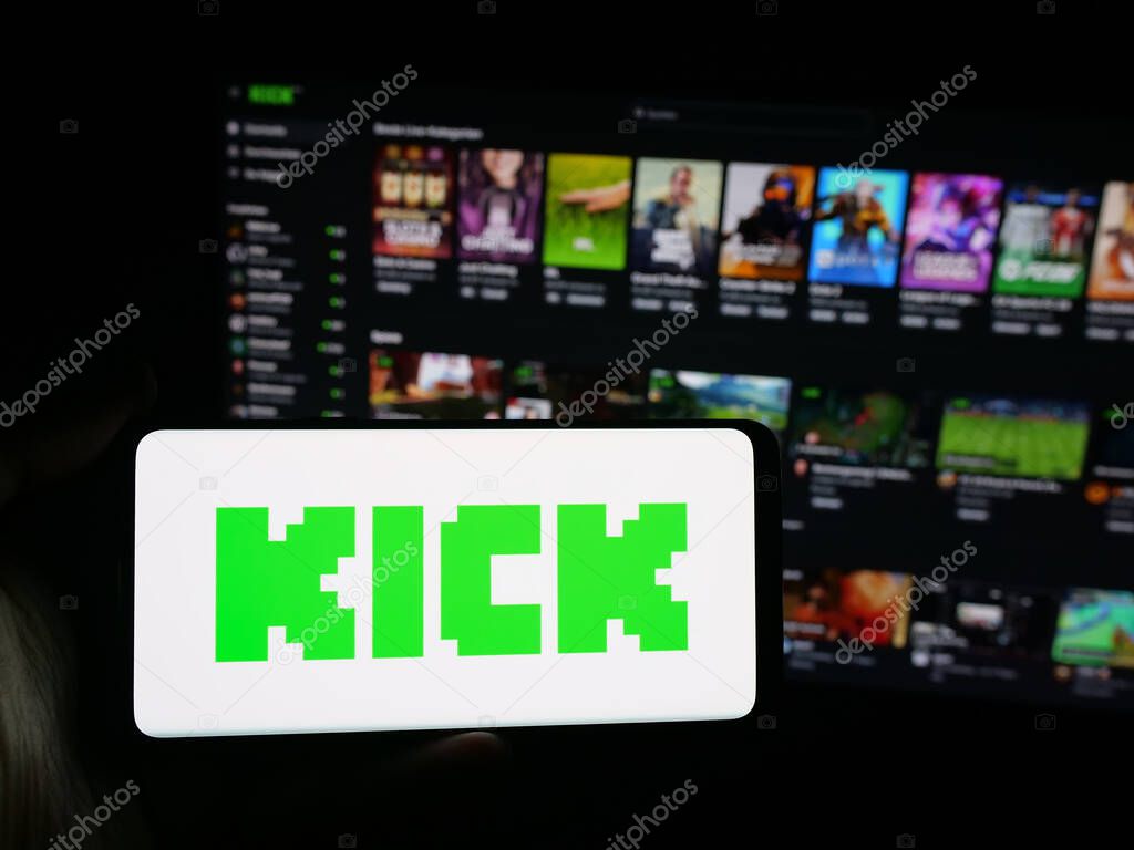 Stuttgart, Germany - 10-06-2025: Person holding smartphone with logo of video livestreaming platform company Kick.com on screen in front of website. Focus on phone display.