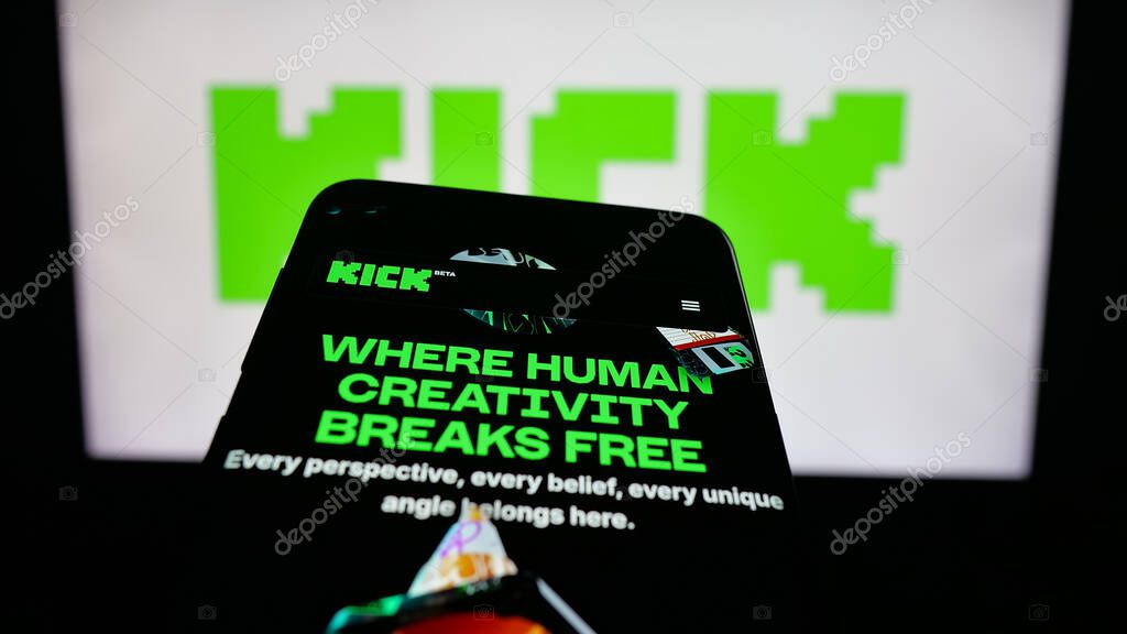 Stuttgart, Germany - 10-06-2025: Mobile phone with website of video livestreaming platform company Kick.com on screen in front of logo. Focus on top-left of phone display.