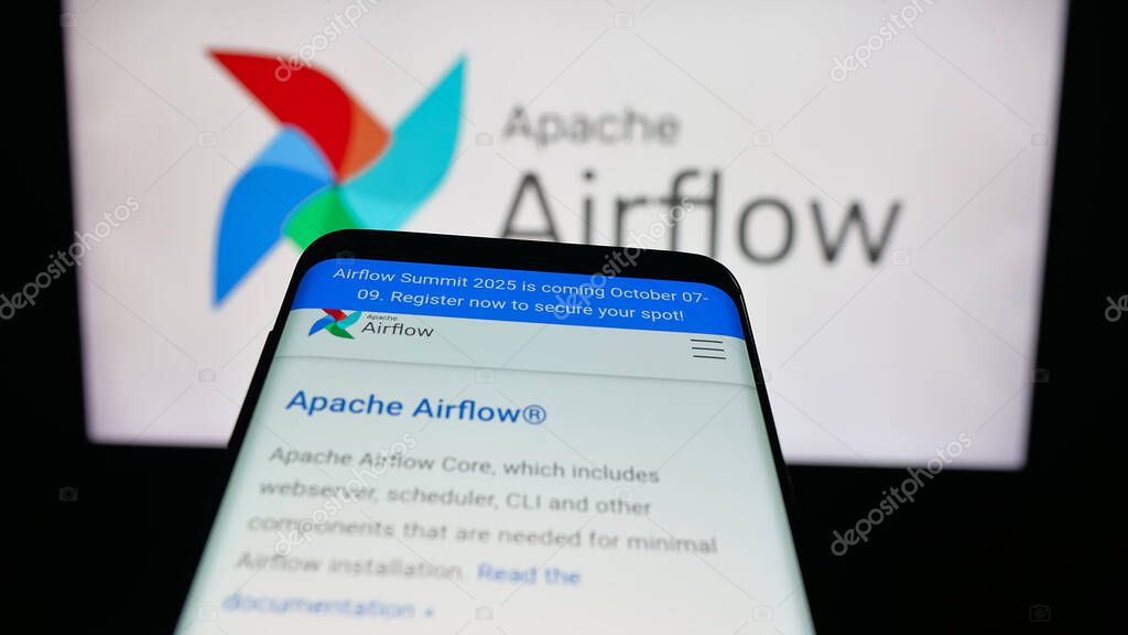 Stuttgart, Germany - 10-08-2025: Mobile phone with website of workflow management platform Apache Airflow on screen in front of logo. Focus on top-left of phone display.