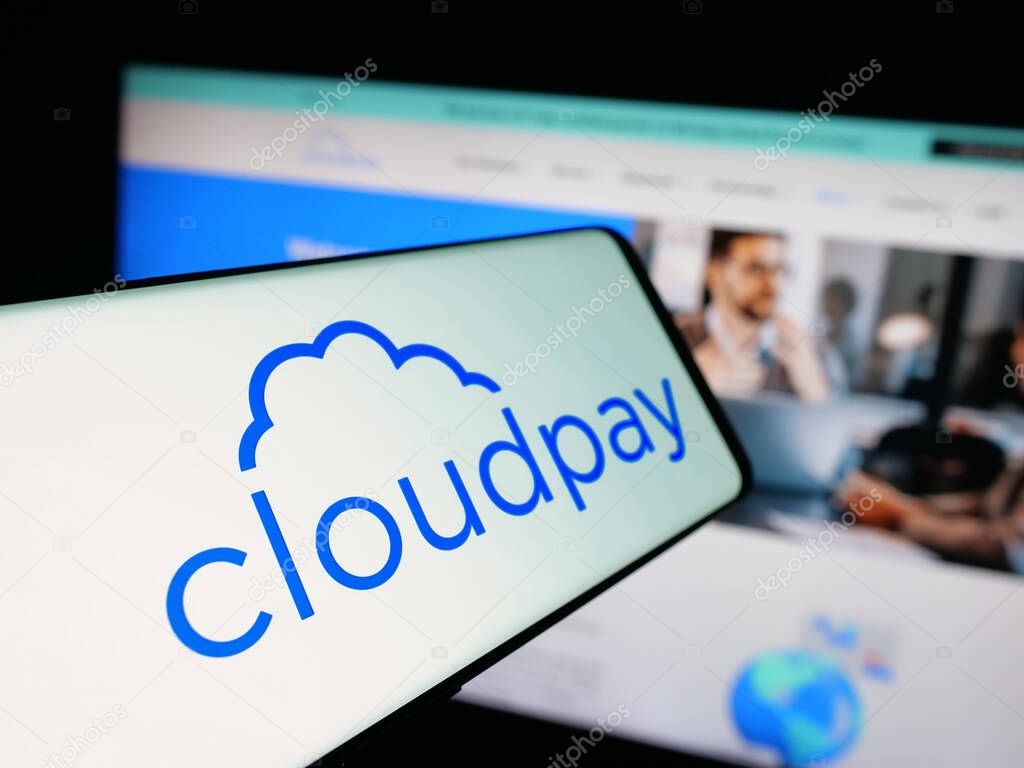 Stuttgart, Germany - 10-08-2025: Smartphone with logo of British payroll services company CloudPay Inc on screen in front of website. Focus on center-left of phone display.
