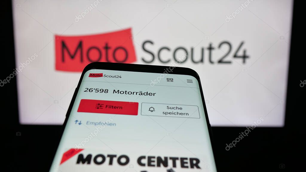 Stuttgart, Germany - 10-09-2025: Mobile phone with website of motorcycle marketplace company MotoScout24 on screen in front of logo. Focus on top-left of phone display.