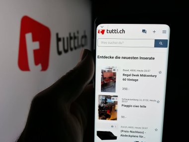 Stuttgart, Almanya - 10-09-2025: Elinde İsviçre 'de sınıflandırılan platform şirketinin özel ders sayfası olan akıllı telefon tutan kişi logonun önünde ekranda. Telefon ekranının merkezine odaklan.