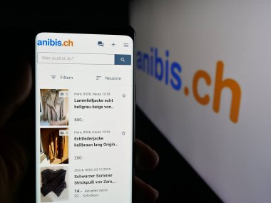 Stuttgart, Almanya - 10-09-2025: İsviçre 'de sınıflandırılan platform şirketi anibis.ch' in web sayfası olan cep telefonu logosu önünde ekranda. Telefon ekranının merkezine odaklan.