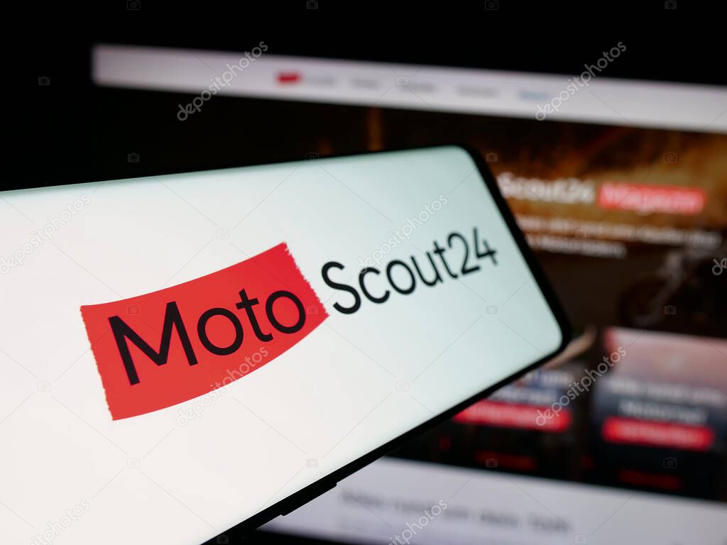 Stuttgart, Germany - 10-09-2025: Smartphone with logo of motorcycle marketplace company MotoScout24 on screen in front of website. Focus on center-left of phone display.