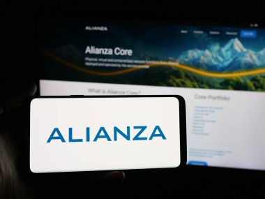 Stuttgart, Almanya - 10-11-2025: İletişim yazılım şirketi Alianza Inc. 'in logosunun bulunduğu akıllı telefonu web sitesinin önünde tutan kişi. Telefon ekranına odaklan.