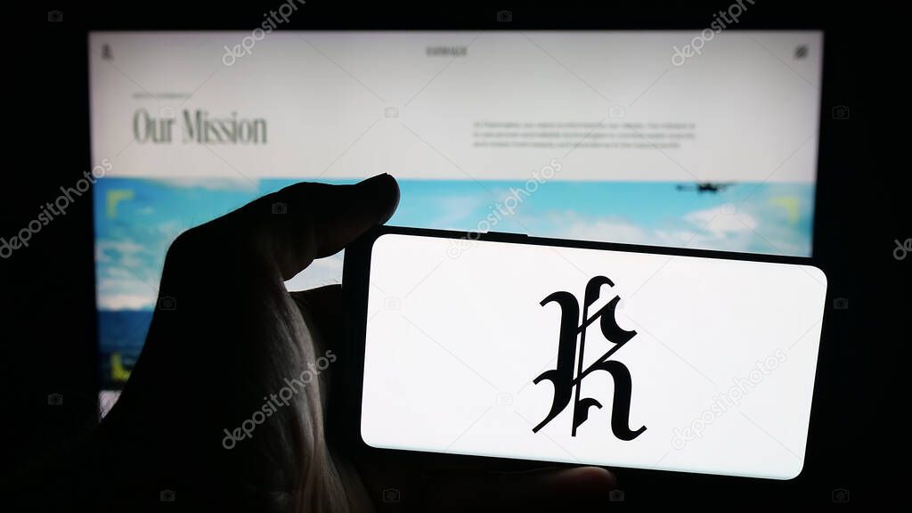 Stuttgart, Germany - 10-15-2025: Person holding mobile phone with logo of cloud seeding company Rainmaker Technology on screen in front of web page. Focus on phone display.