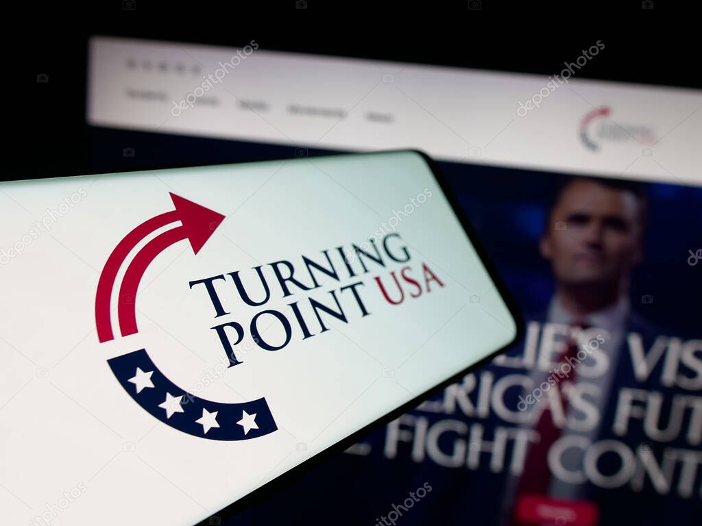 Stuttgart, Germany - 10-15-2025: Smartphone with logo of US organisation Turning Point USA (TPUSA) on screen in front of website. Focus on center-left of phone display.
