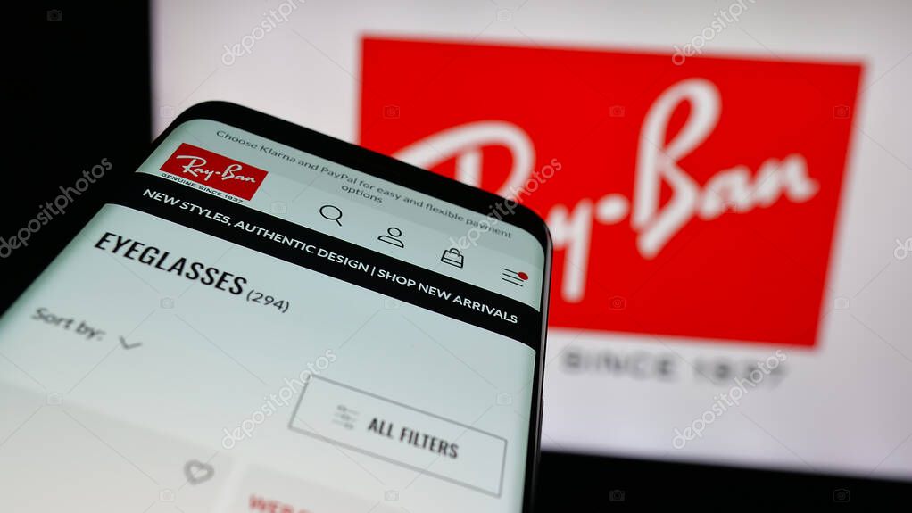 Stuttgart, Germany - 10-16-2025: Mobile phone with website of luxury eyewear company Ray-Ban on screen in front of logo. Focus on top-left of phone display.