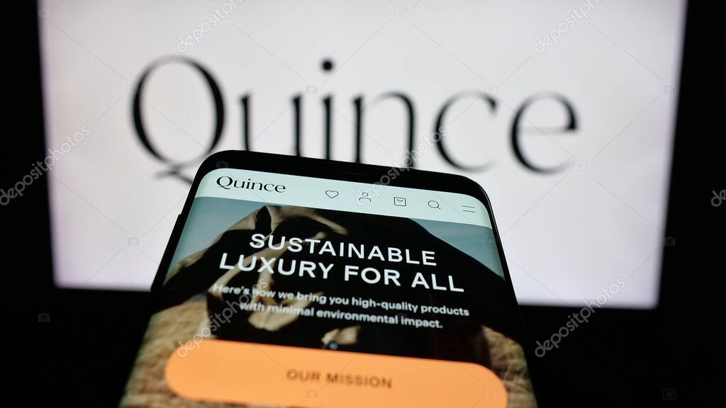 Stuttgart, Germany - 10-20-2025: Mobile phone with website of US fashion company Last Brand Inc. (Quince) on screen in front of logo. Focus on top-left of phone display.