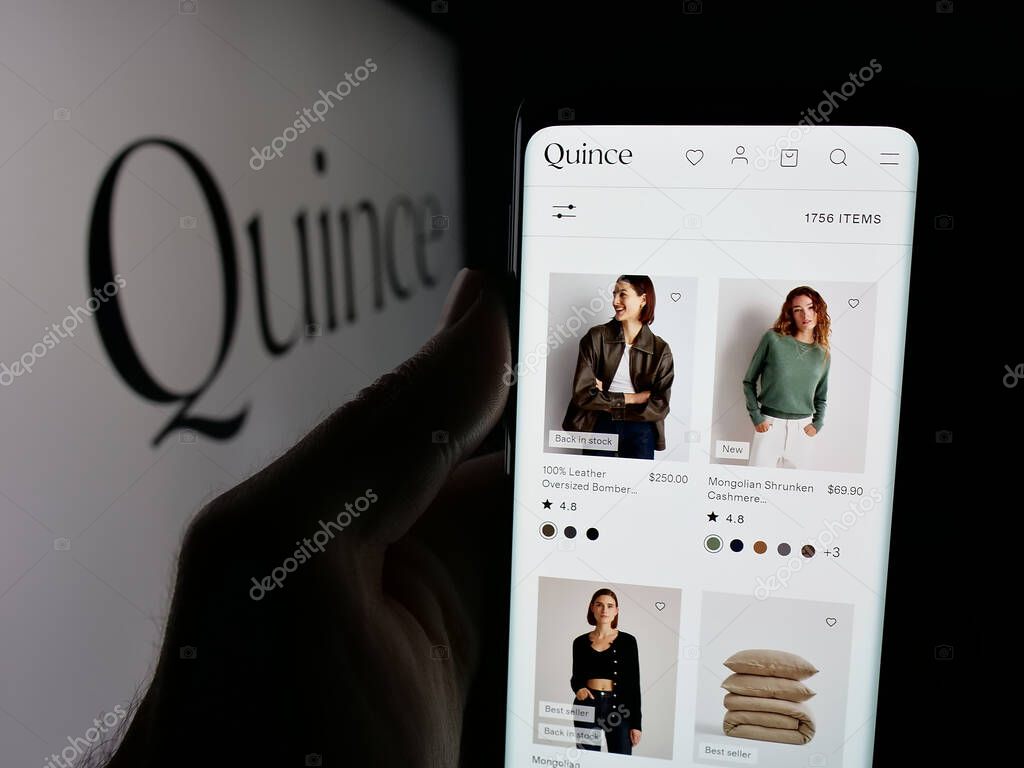 Stuttgart, Germany - 10-20-2025: Person holding smartphone with web page of US fashion company Last Brand Inc. (Quince) on screen in front of logo. Focus on center of phone display.