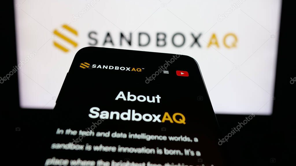 Stuttgart, Germany - 10-20-2025: Mobile phone with website of US company SB Technology Inc. (SandboxAQ) on screen in front of logo. Focus on top-left of phone display.