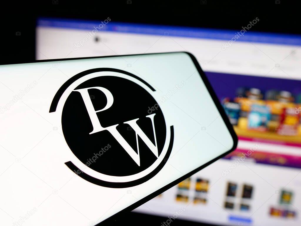 Stuttgart, Germany - 10-25-2025: Smartphone with logo of Indian company Physics Wallah Limited (PW) on screen in front of website. Focus on center-left of phone display.