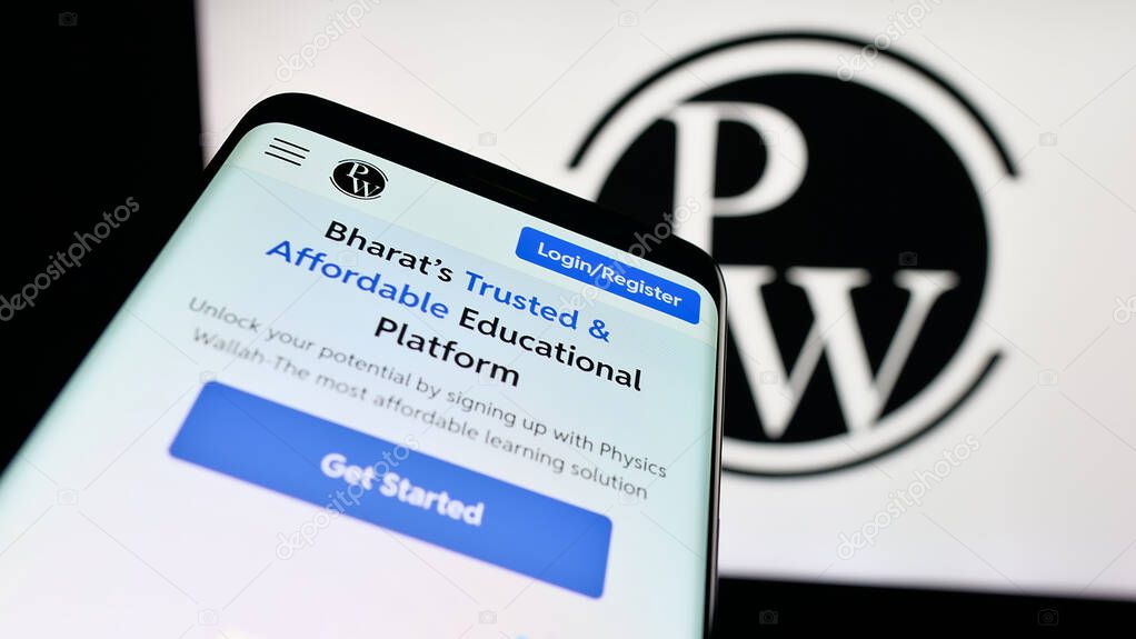 Stuttgart, Germany - 10-25-2025: Mobile phone with website of Indian company Physics Wallah Limited (PW) on screen in front of logo. Focus on top-left of phone display.