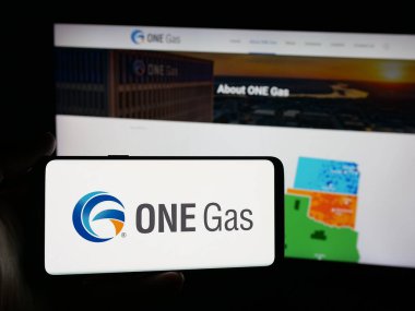 Stuttgart, Almanya - 10-30-2025: ABD 'li doğalgaz şirketi One Gas Inc.' in logosunu taşıyan kişi web sitesinin önünde ekranda. Telefon ekranına odaklan.