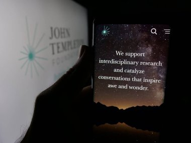 Stuttgart, Almanya - 10-31-2025: ABD organizasyonu John Templeton Vakfı 'nın web sitesi ile akıllı telefon sahibi kişi logo önünde ekranda. Telefon ekranının merkezine odaklan.