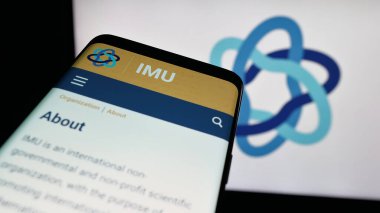 Stuttgart, Almanya - 10-31-2025: Uluslararası Matematik Birliği 'nin (IMU) web sitesi logonun önünde ekranda. Telefon ekranının sol üst kısmına odaklan.