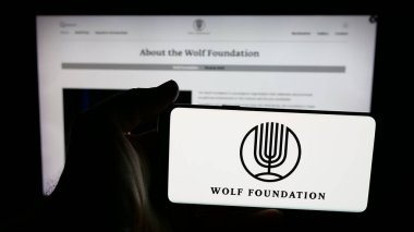 Stuttgart, Almanya - 10-31-2025: İsrail kuruluşu The Wolf Foundation 'ın logosunun bulunduğu cep telefonu web sayfası önünde ekranda. Telefon ekranına odaklan.