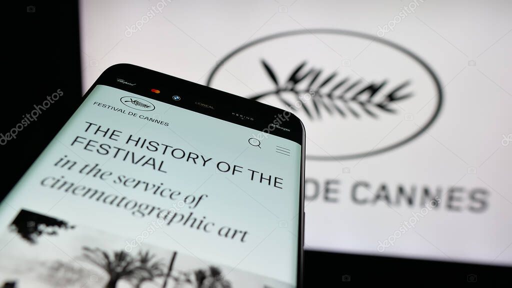Stuttgart, Germany - 10-31-2025: Mobile phone with website of international event Cannes Film Festival on screen in front of logo. Focus on top-left of phone display.