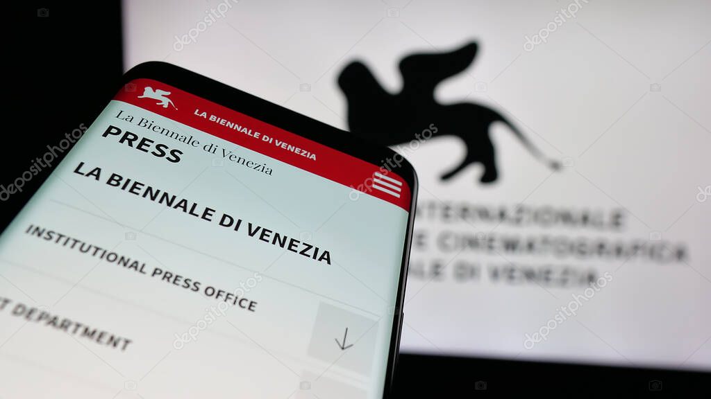 Stuttgart, Germany - 10-31-2025: Mobile phone with website of Venice Film Festival (Biennale) on screen in front of logo. Focus on top-left of phone display.