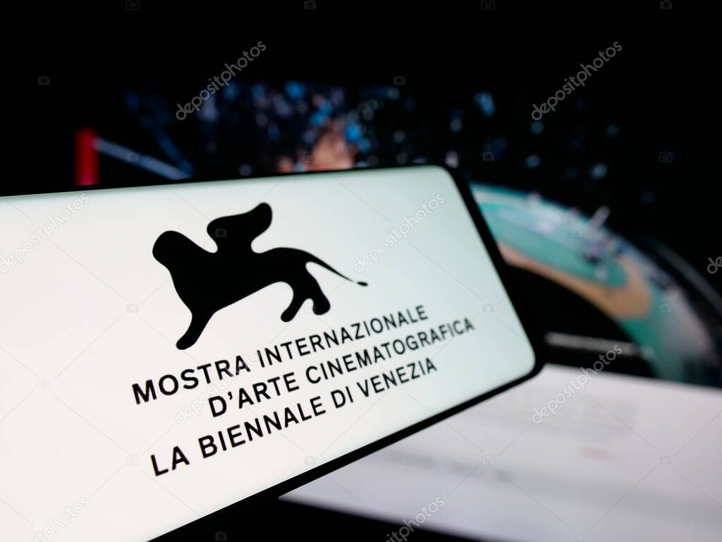 Stuttgart, Germany - 10-31-2025: Smartphone with logo of Venice Film Festival (Biennale) on screen in front of website. Focus on center-left of phone display.
