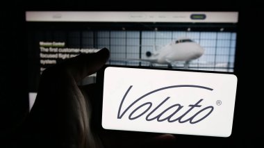 Stuttgart, Almanya - 11-02-2025: ABD 'li özel jet seyahat şirketi Volato Inc.' in logosunun bulunduğu cep telefonu web sayfasının önünde ekranda. Telefon ekranına odaklan.