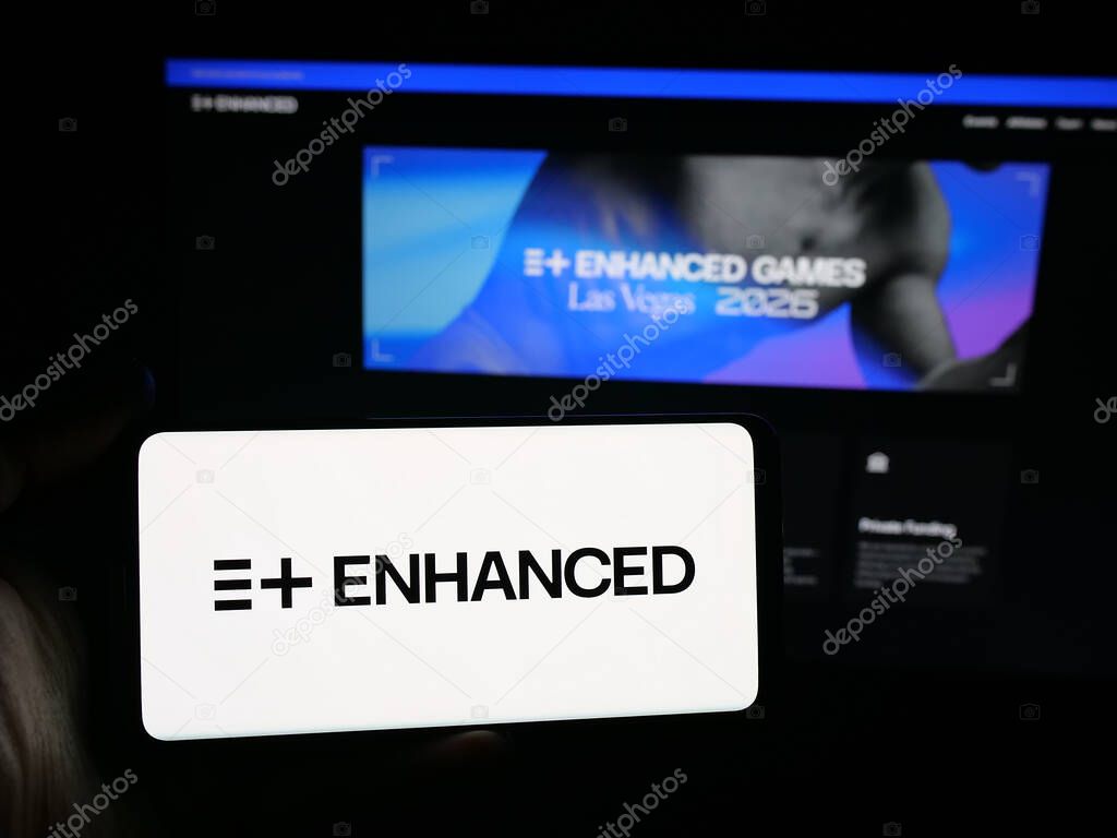 Stuttgart, Germany - 11-02-2025: Person holding smartphone with logo of multi-sport event Enhanced Games on screen in front of website. Focus on phone display.