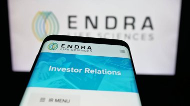 Stuttgart, Germany - 11-03-2025: Mobile phone with website of ultrasound company ENDRA Life Sciences Inc. on screen in front of logo. Focus on top-left of phone display.