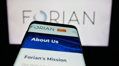 Stuttgart, Germany - 11-03-2025: Mobile phone with website of US software company Forian Inc. on screen in front of logo. Focus on top-left of phone display.