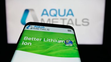 Stuttgart, Germany - 11-04-2025: Mobile phone with website of US metal recycling company Aqua Metals Inc. on screen in front of logo. Focus on top-left of phone display.