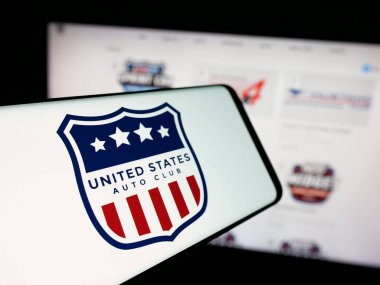 Stuttgart, Germany - 11-04-2025: Smartphone with logo of organisation United States Auto Club (USAC) on screen in front of website. Focus on center-left of phone display.