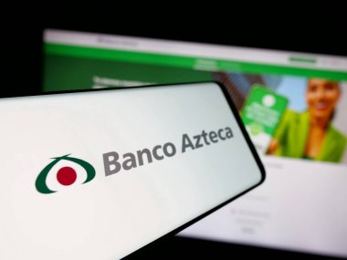 Stuttgart, Germany - 11-05-2025: Smartphone with logo of Mexican financial company Banco Azteca on screen in front of website. Focus on center-left of phone display.