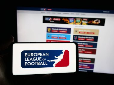 Stuttgart, Germany - 11-05-2025: Person holding smartphone with logo of organisation European League of Football ELF on screen in front of website. Focus on phone display.