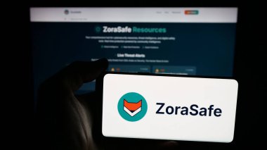 Stuttgart, Germany - 11-05-2025: Person holding mobile phone with logo of US AI cybersecurity company ZoraSafe Inc. on screen in front of web page. Focus on phone display.
