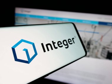 Stuttgart, Germany - 11-05-2025: Smartphone with logo of US company Integer Holdings Corporation on screen in front of website. Focus on center-left of phone display.