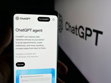Stuttgart, Germany - 11-05-2025: Person holding smartphone with web page of generative AI chatbot ChatGPT (OpenAI) on screen in front of logo. Focus on center of phone display.