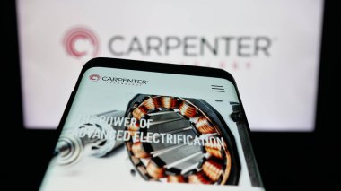 Stuttgart, Germany - 11-05-2025: Mobile phone with website of US company Carpenter Technology Corporation on screen in front of logo. Focus on top-left of phone display.