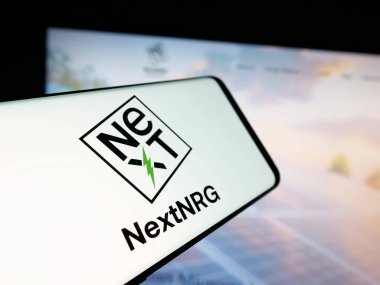 Stuttgart, Germany - 11-06-2025: Smartphone with logo of US fuel distribution company NextNRG Inc. on screen in front of website. Focus on center-left of phone display.