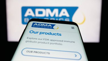 Stuttgart, Germany - 11-07-2025: Mobile phone with website of US biopharma company ADMA Biologics Inc. on screen in front of logo. Focus on top-left of phone display.