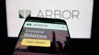 Stuttgart, Germany - 11-07-2025: Mobile phone with website of US REIT company Arbor Realty Trust Inc. on screen in front of logo. Focus on top-left of phone display.