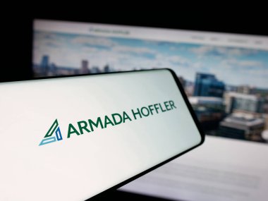Stuttgart, Germany - 11-08-2025: Smartphone with logo of US company Armada Hoffler Properties Inc. on screen in front of website. Focus on center-left of phone display.