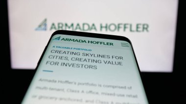 Stuttgart, Germany - 11-08-2025: Mobile phone with website of US company Armada Hoffler Properties Inc. on screen in front of logo. Focus on top-left of phone display.
