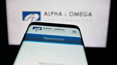 Stuttgart, Germany - 11-08-2025: Mobile phone with website of company Alpha and Omega Semiconductor Limited on screen in front of logo. Focus on top-left of phone display.