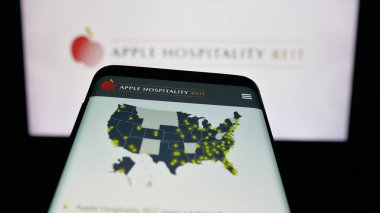 Stuttgart, Germany - 11-08-2025: Mobile phone with website of US company Apple Hospitality REIT Inc. on screen in front of logo. Focus on top-left of phone display.