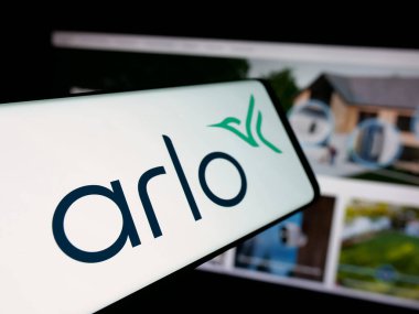 Stuttgart, Germany - 11-12-2025: Smartphone with logo of US CCTV company Arlo Technologies Inc. on screen in front of website. Focus on center-left of phone display.
