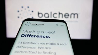 Stuttgart, Germany - 11-12-2025: Mobile phone with website of nutrition and health company Balchem Corp. on screen in front of logo. Focus on top-left of phone display.