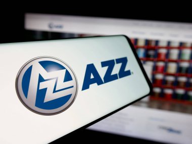 Stuttgart, Germany - 11-12-2025: Smartphone with logo of US coating services company AZZ Inc. on screen in front of website. Focus on center-left of phone display.