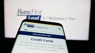 Stuttgart, Germany - 11-12-2025: Mobile phone with website of US financial company BancFirst Corporation on screen in front of logo. Focus on top-left of phone display.