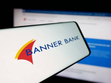 Stuttgart, Germany - 11-12-2025: Smartphone with logo of financial services company Banner Corporation on screen in front of website. Focus on left of phone display.