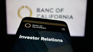 Stuttgart, Germany - 11-12-2025: Mobile phone with website of US banking company Banc of California Inc. on screen in front of logo. Focus on top-left of phone display.